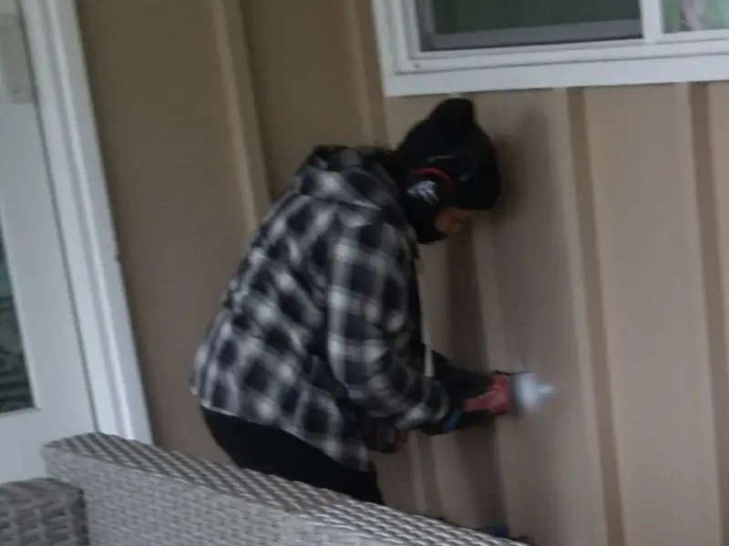 Professional electrician installing an exterior outlet in Robinson