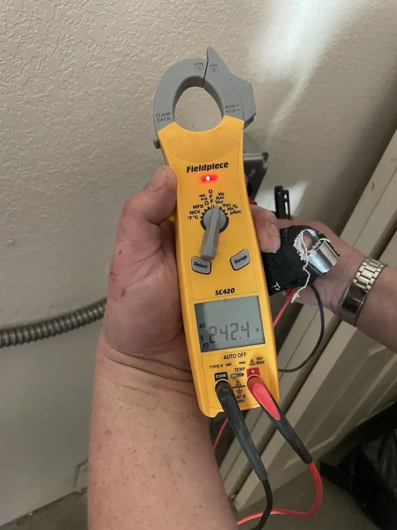 Voltage testing with clamp meter during Whole House Surge Protector in Robinson